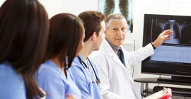 Doctor teaching medical students viewing while viewing an X-Ray